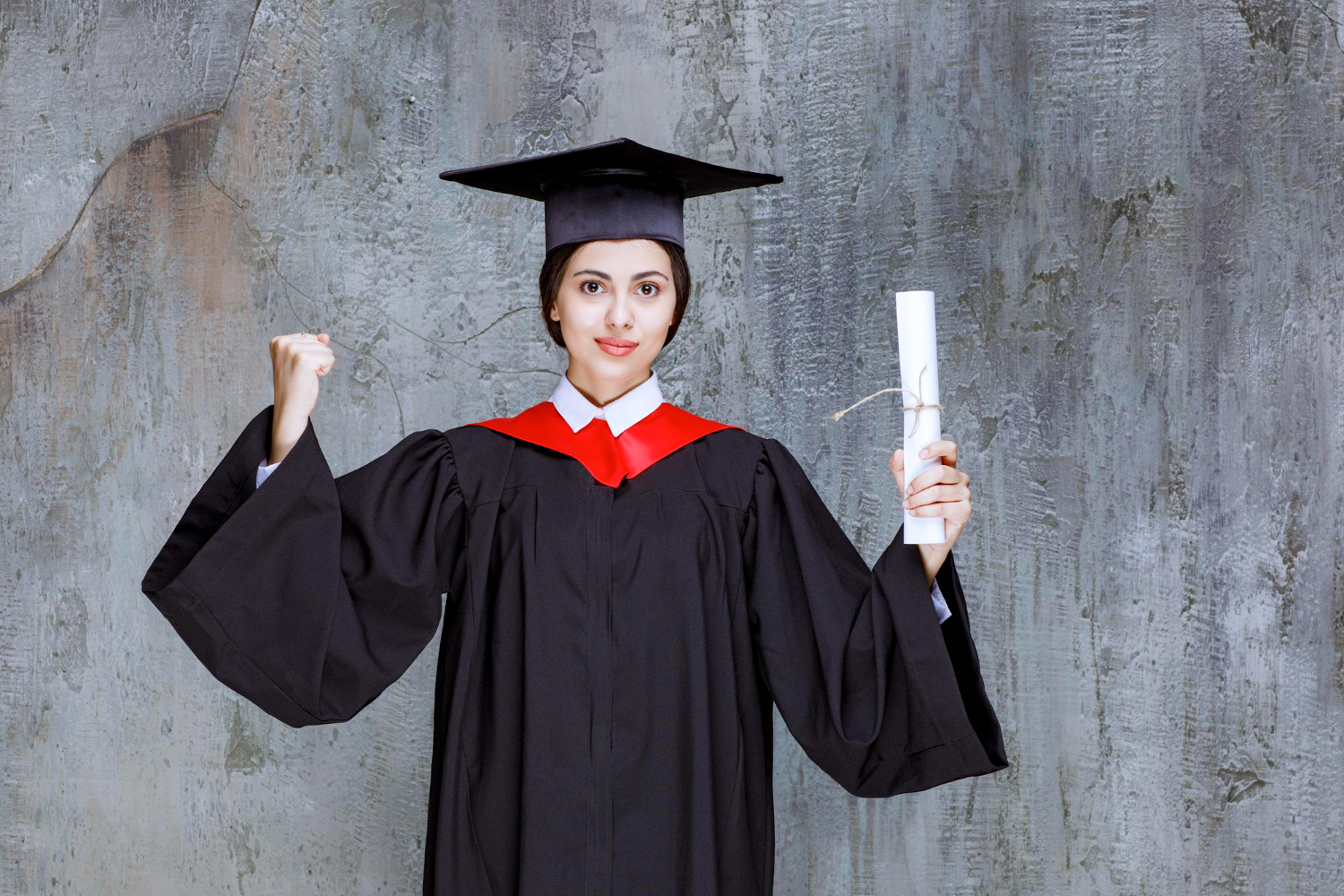 graduated young woman gown holding university diploma