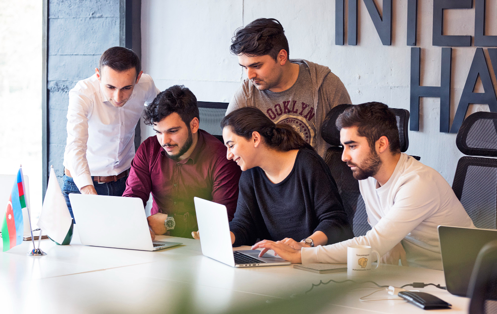 medical coding internships - group of students discussing using labtops